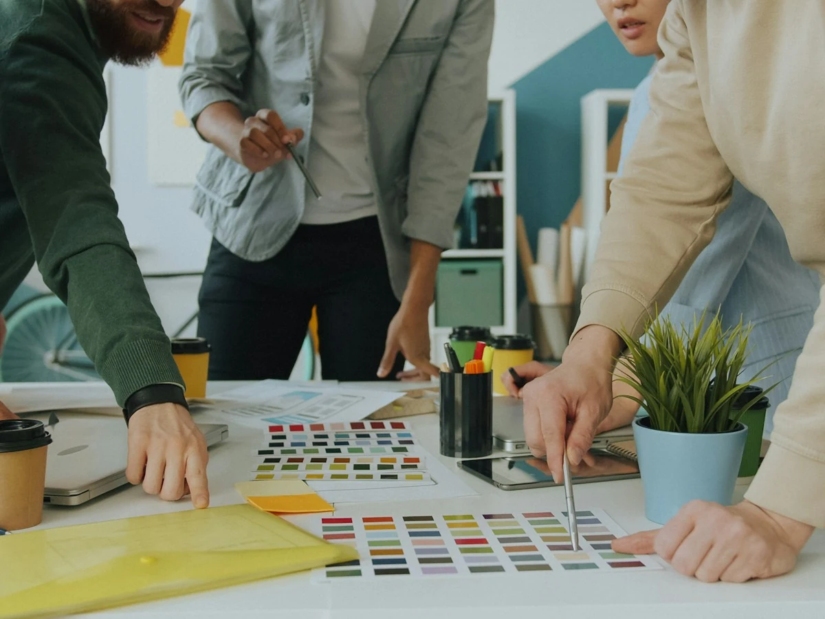 AnimateImage design team arranging color samples on a white table