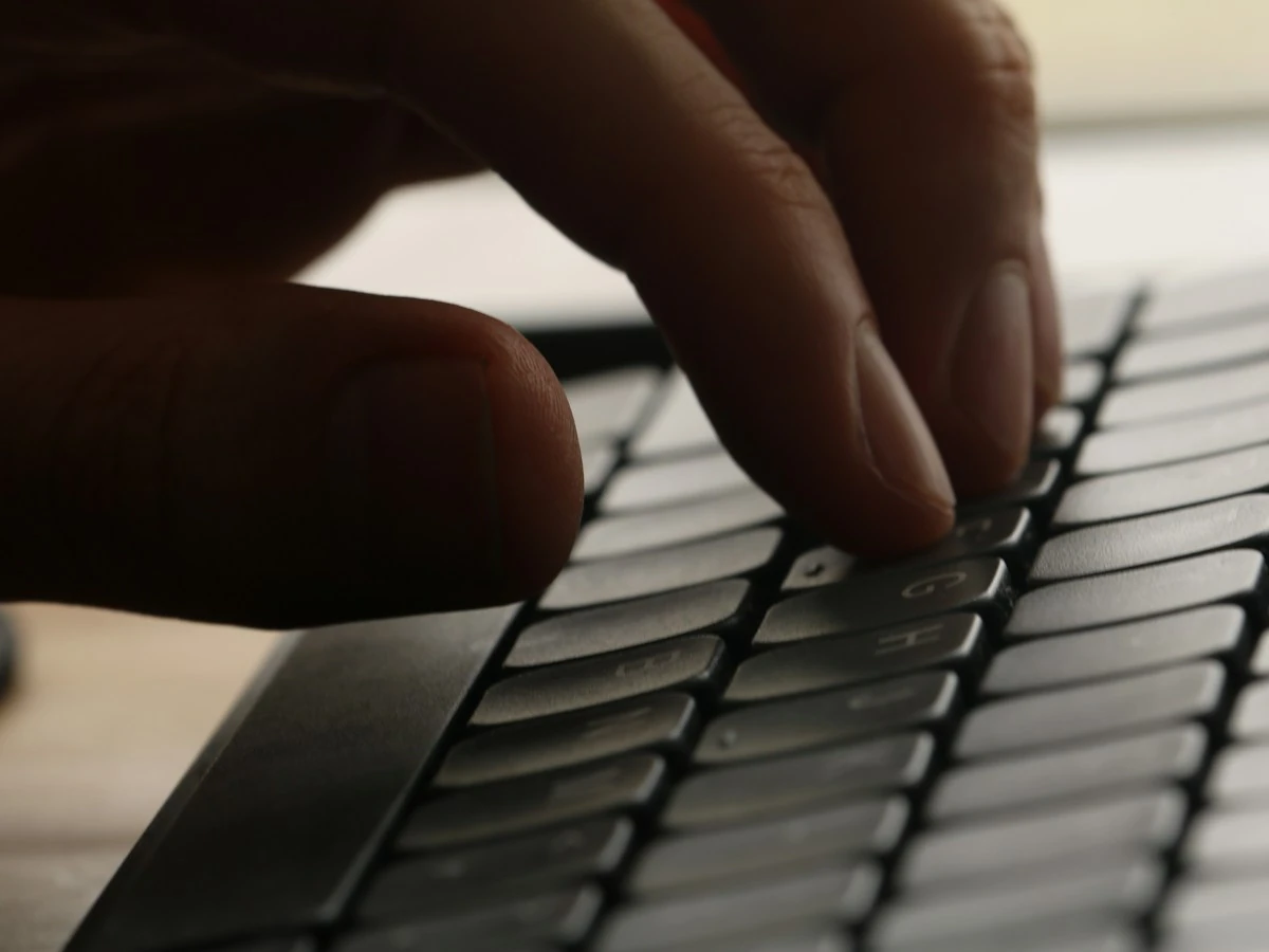 AnimateImage close-up of a hand typing on a dark keyboard