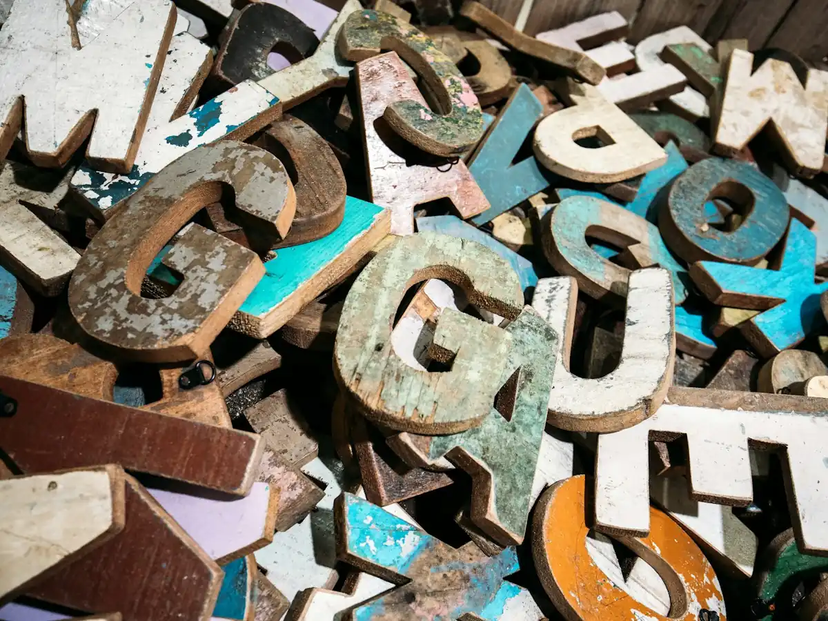 AnimateImage pile of weathered wooden letters in many colors