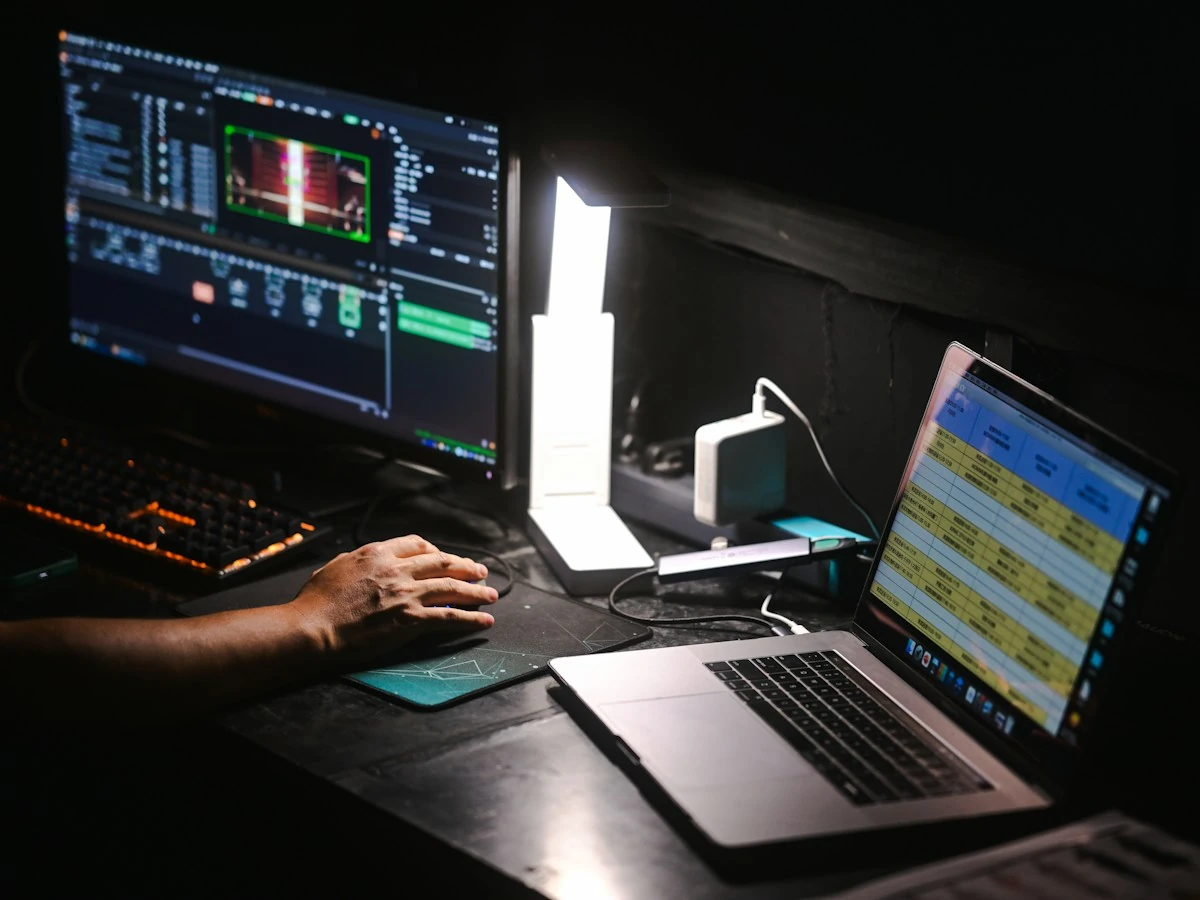 AnimateImage GIF background remover setup: hand on a mouse at a desk with a laptop and monitor