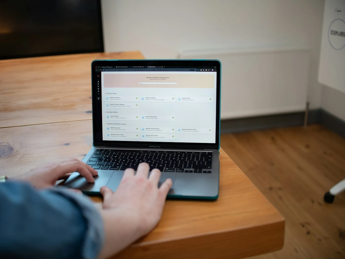 AnimateImage GIF compressor scene: hands working on a laptop at a wooden desk