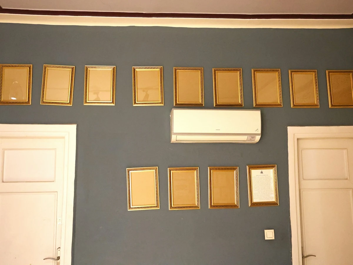AnimateImage gold picture frames arranged on a gray wall