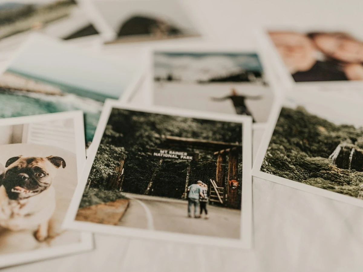 AnimateImage scene: printed photos spread out on a white cloth, ready to order